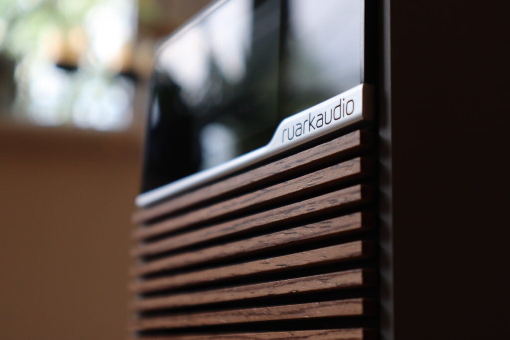 Un regard latéral sur le logo Ruark R1S et la calandre en noyer