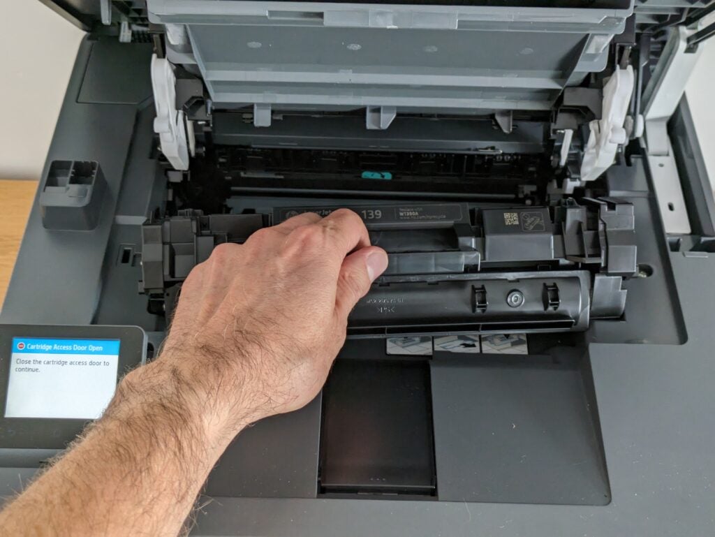Photo de la cartouche de toner en cours de réinsertion